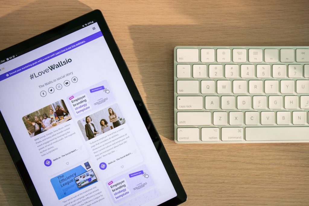 Tablet displaying social media on desk with keyboard, highlighting connectivity and technology.